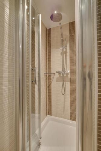 a bathroom with a shower with a glass shower stall at 2 Bed in Aberaeron oc-bow173 in Aberaeron