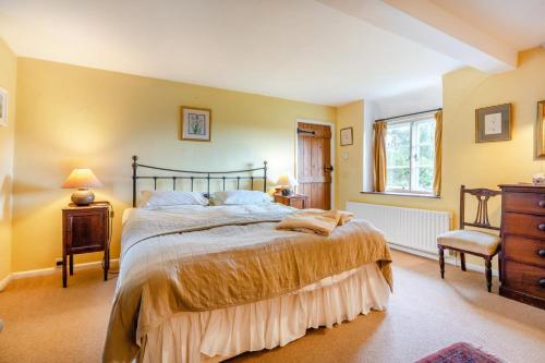 a bedroom with a large bed and a window at 4 Bed in Arne oc-wy343 in Arne
