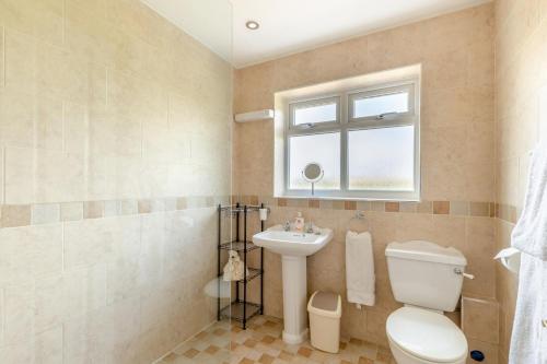 a bathroom with a toilet and a sink and a window at 1 Bed in Flore oc-b32437 in Flore