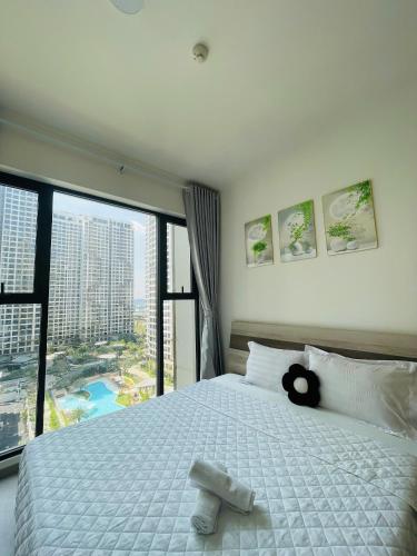 a bedroom with a bed with a teddy bear on it at 2 Bedrooms Masterise Center Point C Vinhomes Grand Park in Long Bình