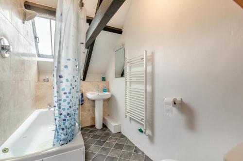 a bathroom with a shower and a sink and a tub at 2 Bed in Chideock oc-g32451 in Chideock