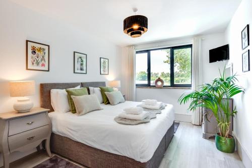 a bedroom with a bed with white sheets and a window at 5 Bed in Briston oc-2304 in Briston