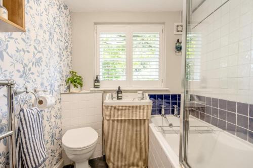 a bathroom with a toilet and a tub and a sink at 2 Bed in Dedham oc-c32543 in Dedham
