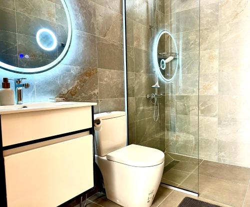a bathroom with a toilet and a shower at Residence Azelina in Pointe aux Canonniers