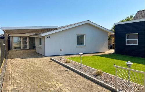 a white house with a brick driveway at Awesome Home In Thyborøn With Wifi in Thyborøn