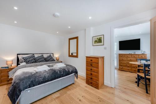 a bedroom with a bed and a desk and a television at 1 Bed in Yapton oc-b32757 in Yapton