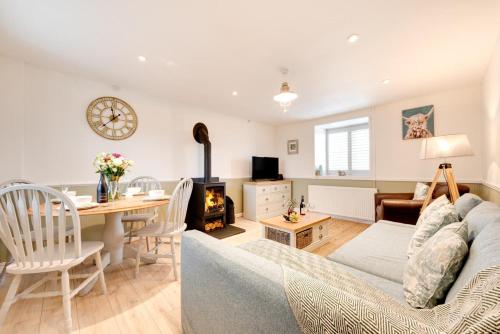 a living room with a couch and a dining room at 2 Bed in Sennen oc-flora in Sennen
