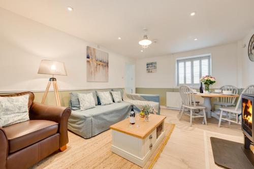 a living room with a couch and a table at 2 Bed in Sennen oc-flora in Sennen