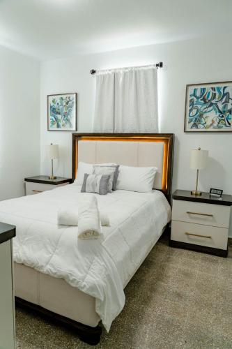 a bedroom with a large white bed with two night stands at Relax San Juan in San Juan