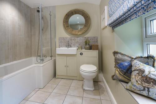a bathroom with a toilet and a sink and a tub at 2 Bed in Pwllheli oc-30aber in Pwllheli