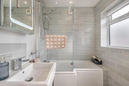 a bathroom with a white tub and a sink at 2 Bed in Aldborough oc-2257 in Thurgarton