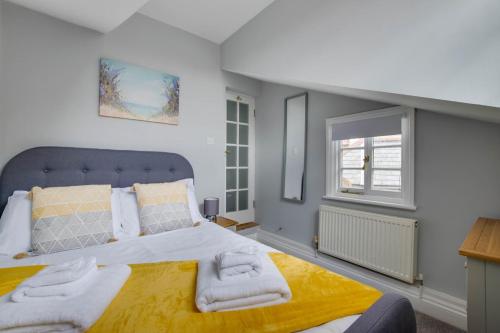 a bedroom with a large bed with towels on it at 2 Bed in Southwold oc-eastgn in Southwold