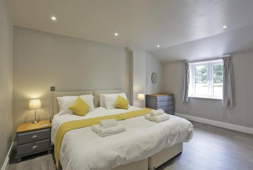 a bedroom with two beds and a window at 3 Bed in Barsham oc-bbarn in Beccles