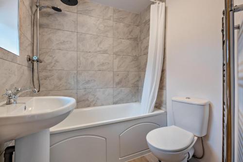 a bathroom with a toilet and a sink and a tub at 2 Bed in Lavenham oc-f30054 in Lavenham