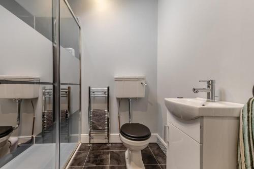 a bathroom with a toilet and a sink and a shower at 5 Bed in Biddlestone oc-b30105 in Alnham