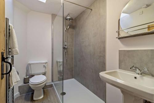 a bathroom with a shower and a toilet and a sink at 2 Bed in Lavenham oc-t30056 in Lavenham