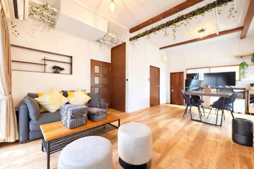 a living room with a couch and a table at 5 min Walk Noborito 16 mins Shinjuku,3 BR, 2 Bath in Kawasaki