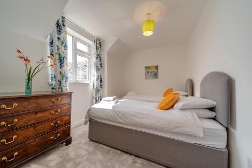 a bedroom with a bed with a dresser and a window at 3 Bed in Clachan oc-h32242 in Clachan