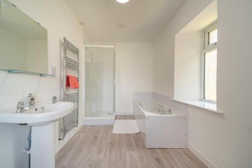a white bathroom with a sink and a tub at 3 Bed in Clachan oc-h32242 in Clachan
