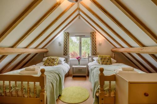 two beds in a attic bedroom with a roof at 2 Bed in Rumburgh oc-dgf in Rumburgh