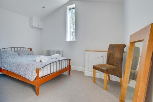 a bedroom with a bed and a chair at 2 Bed in Sotherton oc-dailo in Blyford