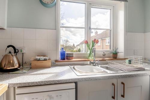 a kitchen counter with a sink and a window at 2 Bed in Halesworth oc-rect in Halesworth