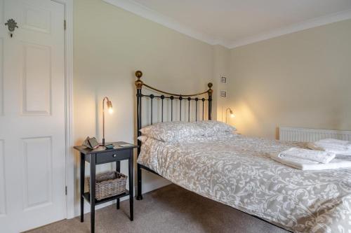 a bedroom with a bed and a table with a lamp at 2 Bed in Halesworth oc-rect in Halesworth