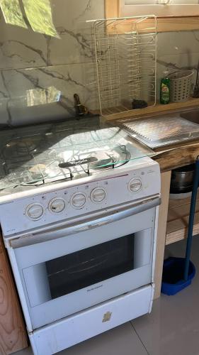 a white stove top oven in a kitchen at Rukas Huinkaray in Pucón
