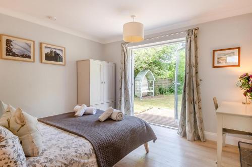 a bedroom with a bed and a desk and a window at 3 Bed in Westleton oc-egv in Westleton