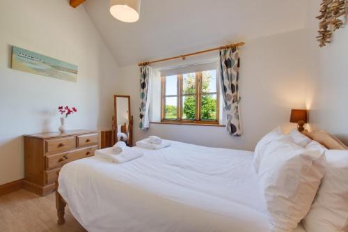 a bedroom with a white bed and a window at 2 Bed in Roughton oc-1734 in Roughton
