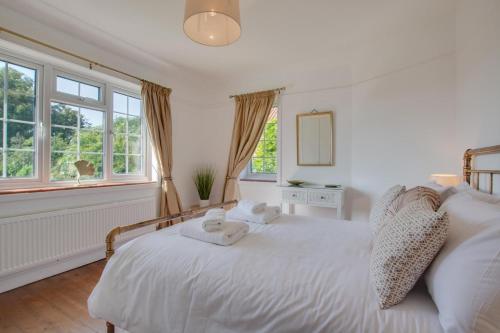 a bedroom with a white bed with towels on it at 5 Bed in Mundesley oc-2189 in Mundesley