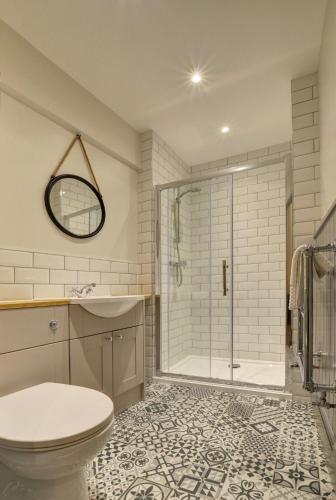 a bathroom with a shower and a toilet and a sink at 2 Bed in Appledore oc-hide1 in Appledore