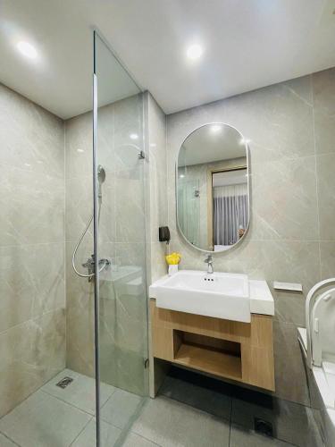 a bathroom with a sink and a shower at 2 Bedrooms Masterise Center Point C Vinhomes Grand Park in Long Bình