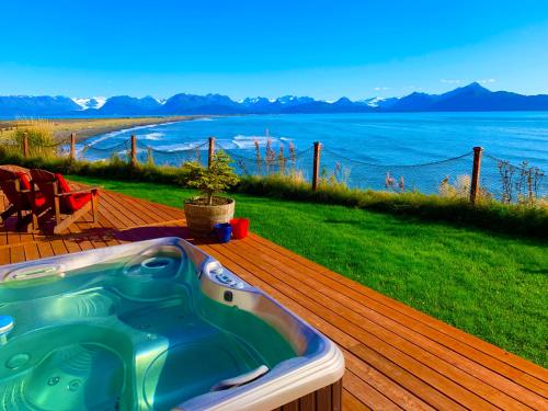 a hot tub on a deck with a view of the ocean at Oceanhouse in Homer