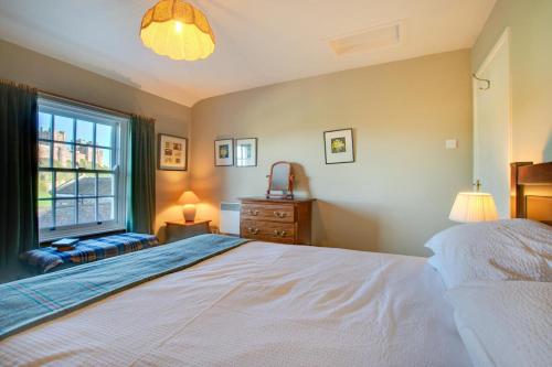 a bedroom with a large white bed and a window at 2 Bed in Bamburgh oc-gd0248 in Bamburgh