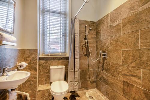 a bathroom with a shower and a toilet and a sink at 3 Bed in Bessingham oc-b28837 in Thurgarton