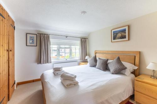 a bedroom with a bed with two towels on it at 1 Bed in Holt oc-1838 in Holt