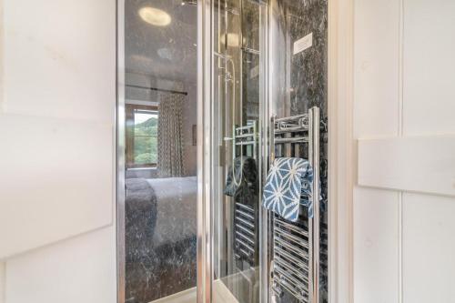 a closet with a glass door with a shelf at 3 Bed in Withypool oc-o18550 in Withypool