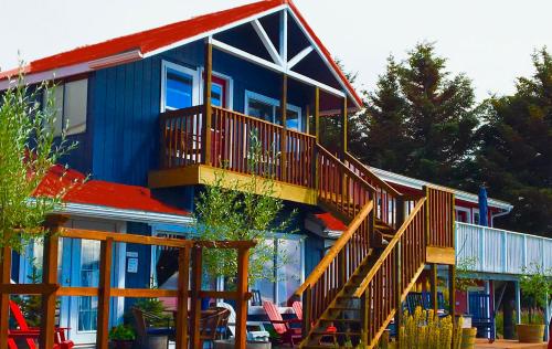 a blue house with wooden stairs in front of it at Oceanhouse in Homer