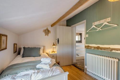 a small bedroom with a bed and a hallway at 2 Bed in Wiveton oc-g29762 in Wiveton