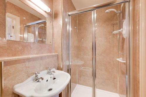 a bathroom with a sink and a shower at 6 Bed in Keswick oc-ld177 in Keswick