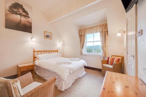 a bedroom with a bed and a table and chairs at 6 Bed in Keswick oc-ld177 in Keswick
