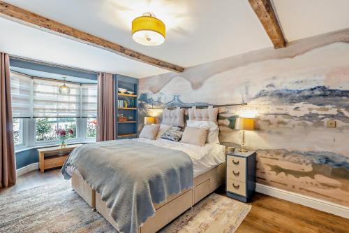 a bedroom with a large bed with a painting on the wall at 4 Bed in Ruthin oc-a29543 in Ruthin