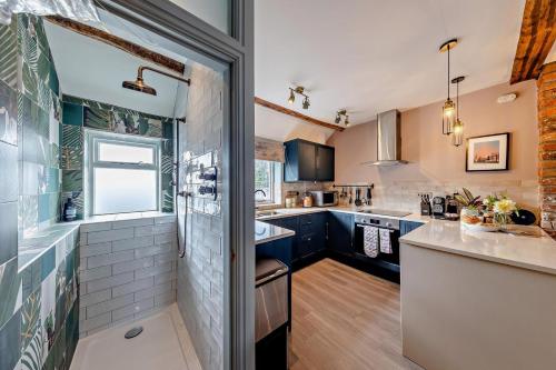 a kitchen with blue cabinets and a sink at 4 Bed in Ruthin oc-a29543 in Ruthin