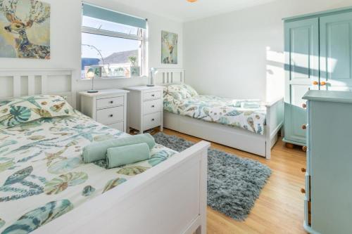 a bedroom with two beds and a window at 2 Bed in Mullion oc-k7968 in Mullion