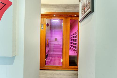 a hallway with pink walls and a wooden door at 5 Bed in St. Fillans oc-t30058 in Saint Fillans