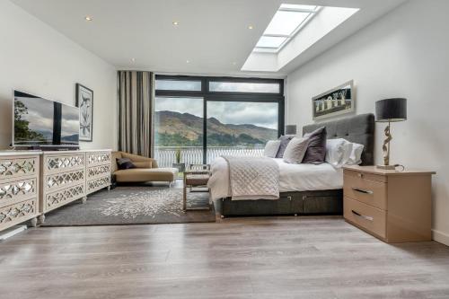 a bedroom with a bed and a large window at 5 Bed in St. Fillans oc-t30058 in Saint Fillans