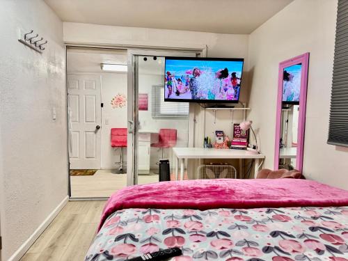 a bedroom with a bed and a flat screen tv at Cozy 1 Bedroom Apartment 10 minutes to SeaTac Airport in Seattle
