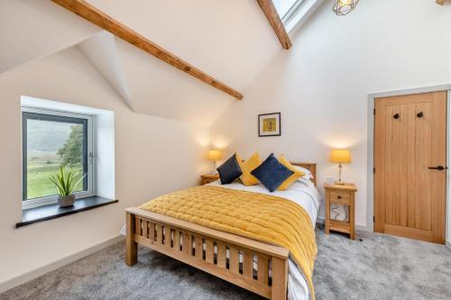 a bedroom with a bed and a window at 2 Bed in Penmaenpool oc-m30050 in Arthog