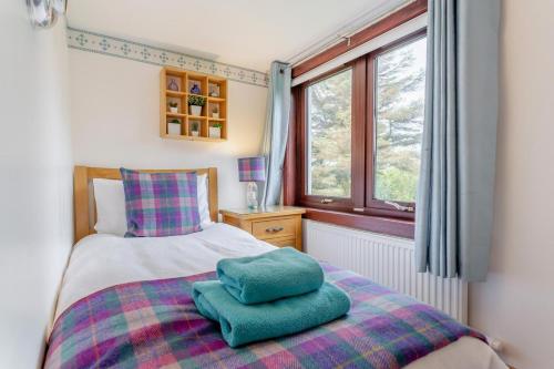 a bedroom with a bed with two pillows on it at 3 Bed in Isle Of Skye oc-r31786 in Broadford